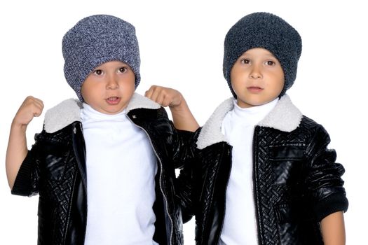 Studio portrait of boys in black leather jackets.Isolated on white background.