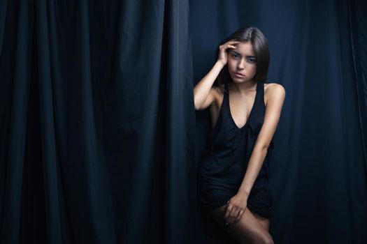 sensuall brunette woman in underwear, studio shot, dark background