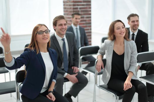 Elegantly dressed lady proposing her idea for company's strategy