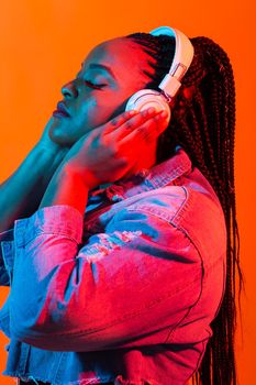 Portrait of beautiful African American woman joyful listening to music