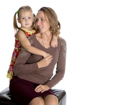 Young mother and little daughter gently embrace. The concept of Happy Childhood, Family Happiness, Raising a Child. Isolated on white background.