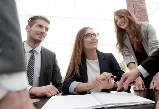 Businesswoman standing and leading business presentation.