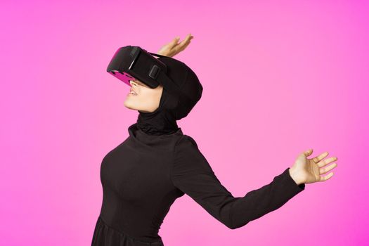 woman in black hijab glasses virtual reality technology movie watching. High quality photo
