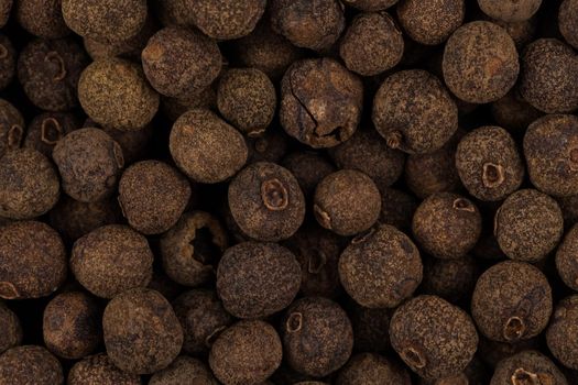 Large black pepper seeds corns as a background