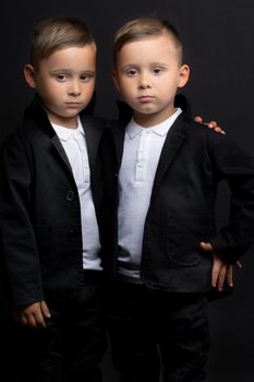 two little boys dressed in tuxedo. Isolated on white background