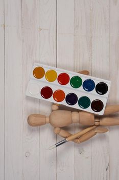 watercolor paint multicolored stickers drawing items wooden background. High quality photo