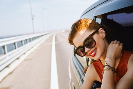 pretty woman in sunglasses rides in a travel car. High quality photo