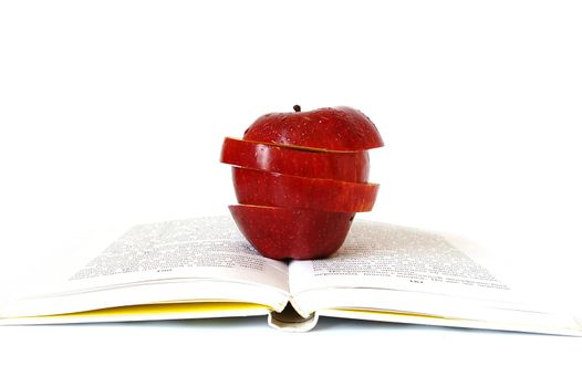 Pieces of apple on the book isolated