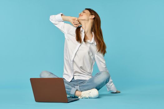 woman with laptop learning internet online education blue background. High quality photo