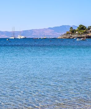 Blue sea, boats, mountains and islands on the Aegean coast. Summer vacation and coastal nature concept