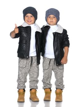 Studio portrait of boys in black leather jackets.Isolated on white background.