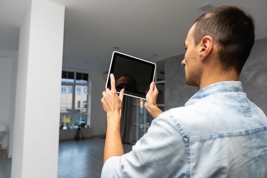 Smart Home: Man Controlling Blinds With His tablet.