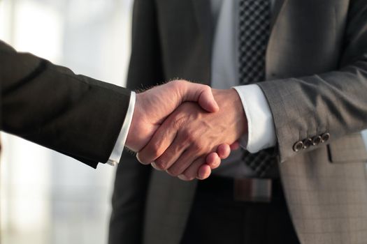 close up. handshake business partners .the concept of cooperation