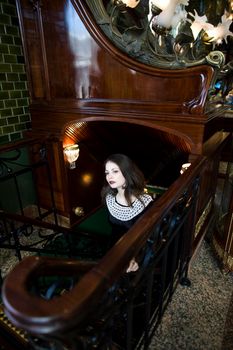 young elegant brunette rich woman in cafe drinking coffee, luxury vintage interior