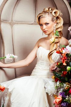 beauty young bride alone in luxury vintage interior with a lot of flowers, makeup and creative hairstyle close up