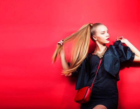 young pretty woman young lady posing on red background, lifestyle people concept close up