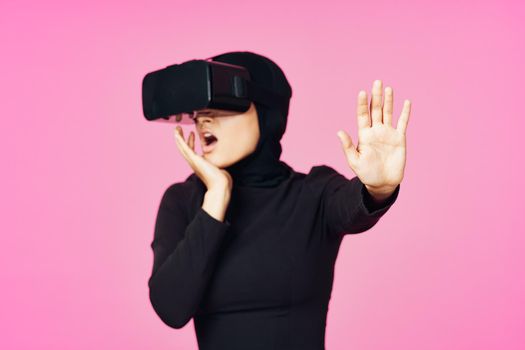 muslim woman wearing virtual reality glasses entertainment technology device. High quality photo
