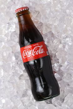 IRVINE, CALIFORNIA - 26 JUNE 2021: A glass bottle of Coca-Cola in a bed of ice.