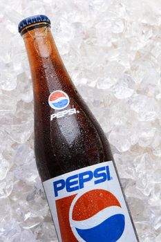 IRVINE, CA - JUNE 9, 2014: Closeup of a bottle of Pepsi soda in ice. Originally named "Brad's Drink" it was later changed to Pepsi Cola after the digestive enzyme pepsin and kola nuts used in the recipe.