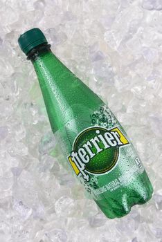 IRVINE, CALIFORNIA - DECEMBER 17, 2017: Perrier Sparkling Mineral Water on ice. The spring, in Vergeze, France, where the water is sourced is naturally carbonated.