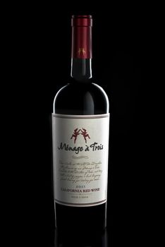 IRVINE, CA - 22-DEC 2020: A 750 ml bottle of Menage a Trois California Red Wine 2017 vintage. Produced by the award winning winery Folie a Deux in Sonoma.