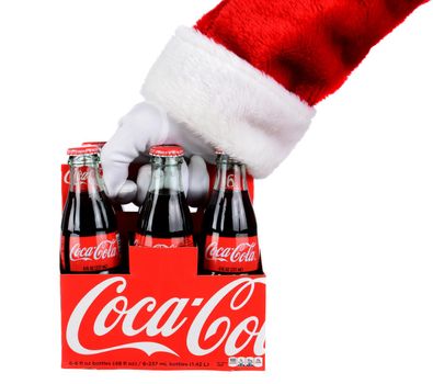 IRVINE, CA - DECEMBER 12, 2014: Santa Claus holding a 6 pack of Coca-Cola Classic bottles. Coca-Cola is the one of the worlds favorite carbonated beverages.