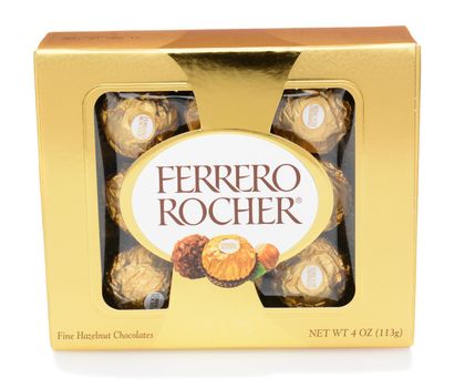 IRVINE, CA - DECEMBER 12, 2014: A box of Ferrero Rocher Chocolates. Since 1982, the candy consists of a whole roasted hazelnut in a thin wafer shell filled with hazelnut cream coated in milk chocolate.