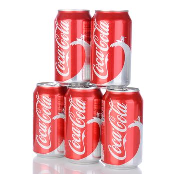 IRVINE, CA - January 05, 2014: Photo of 5, 12 ounce cans of Coca-Cola Classic, with wave and surfer design. Coca-Cola is the one of the worlds favorite carbonated beverages.