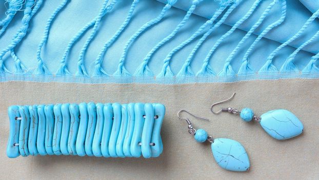 Turquoise bracelet and earrings from natural stone on fringed scarf