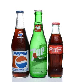 IRVINE, CA - FEBRUARY 19, 2015: Pepsi, Coca-Cola and 7-Up bottles. Three bottles of the most popular soft drinks in the Ubited States on white with condensation.