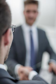 close up.smiling business people shaking hands in office.business concept