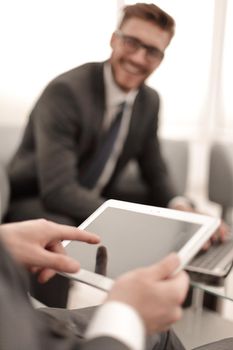 close up.businessman tapping the screen of the digital tablet. new technology concept