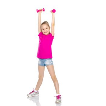 A cute little girl doing exercises with dumbbells. The concept of strength, health and sport. Isolated on white background.