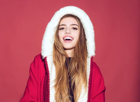 Happy christmas woman in santa claus hat with hood on red background, happy girl at new year party celebration