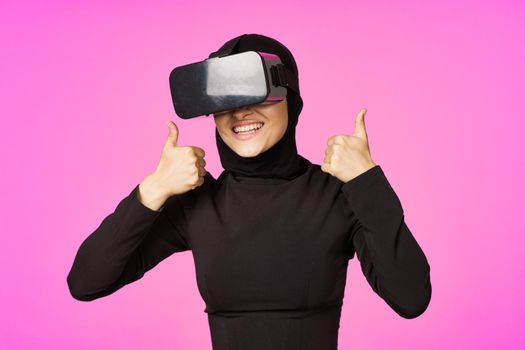 muslim woman wearing virtual reality glasses entertainment technology device. High quality photo