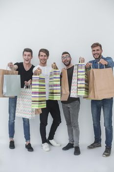 group of young men shows shopping bags. photo with copy space