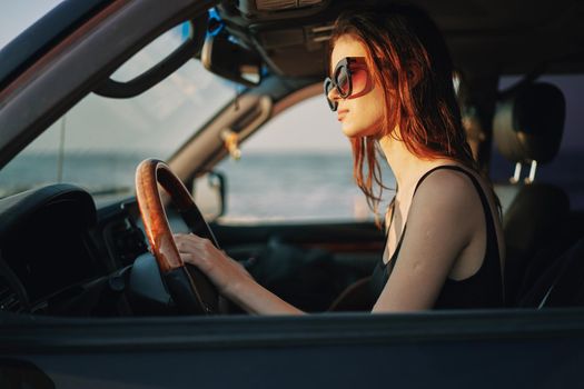 pretty woman in sunglasses driving a car trip. High quality photo