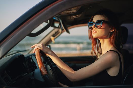 pretty woman in sunglasses driving a car trip. High quality photo