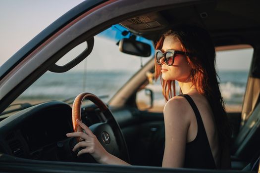 pretty woman in sunglasses driving a car trip. High quality photo