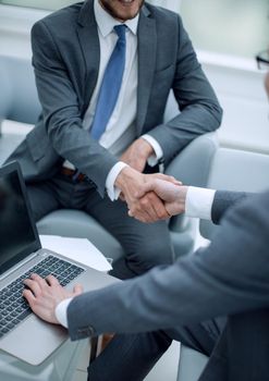 close up. businessman shaking hands with business partner.the concept of cooperation