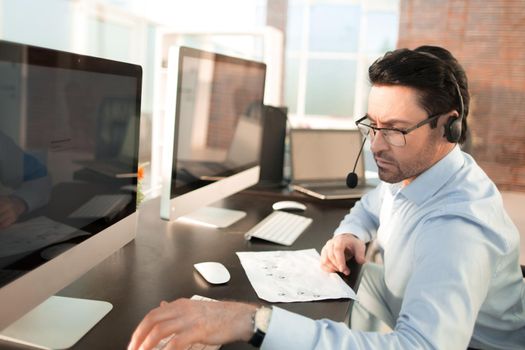 businessman analyzes the data sitting in the office.people and technology