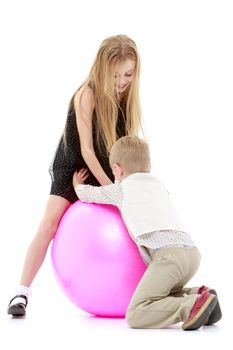 Toddler boy and girl playing with ball. The concept of a harmonious development of a child in the family, a happy childhood. Isolated on white background.