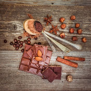 coffee beans and chocolate on a wooden background.
