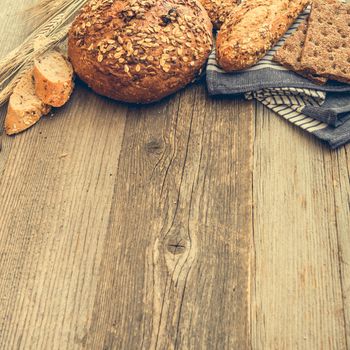 Different types of bread on a wooden background