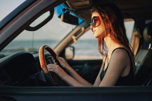 pretty woman in sunglasses driving a car trip. High quality photo