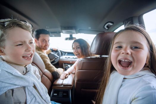children sitting in the back seat of the car. family holiday