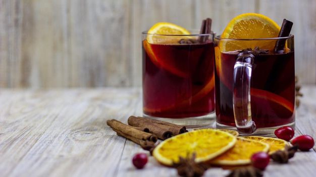 glasses with mulled wine on wooden background. new year concept. Selective focus