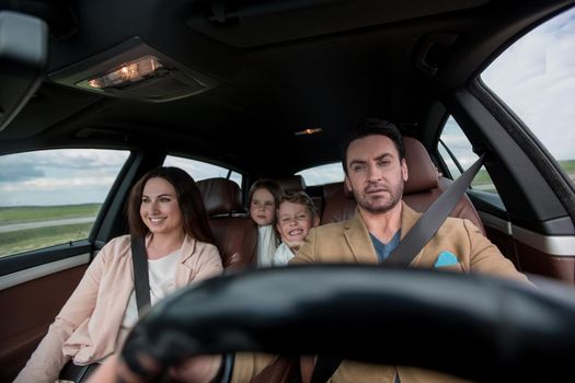 father fastens his seat belt sitting in the car.security concept