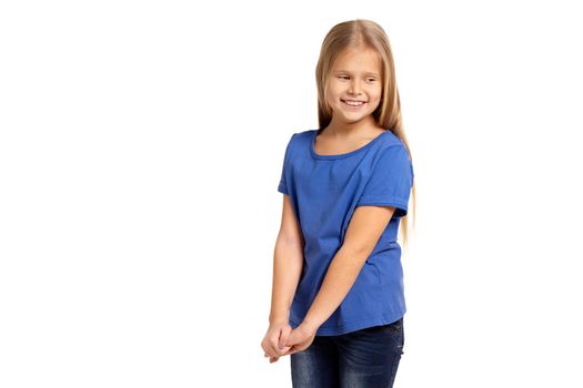 Portrait of adorable little girl isolated on a white background. in blue t-short with long white hair, shying stand