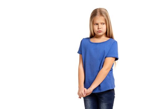 Portrait of adorable little girl isolated on a white background. in blue t-short with long white hair, shying stand
